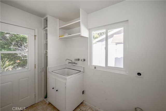 washroom featuring hookup for an electric dryer, plenty of natural light, and a sink