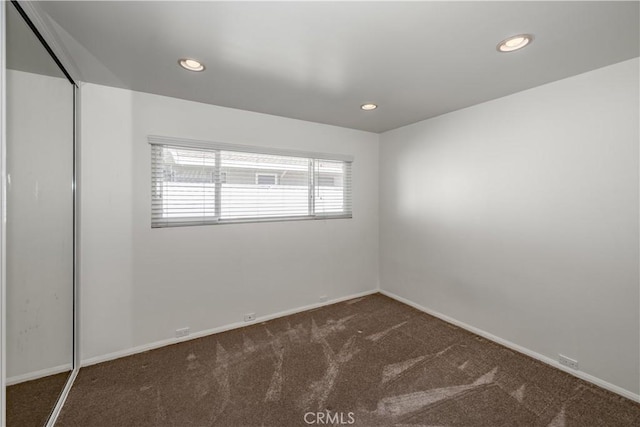 carpeted spare room with recessed lighting and baseboards