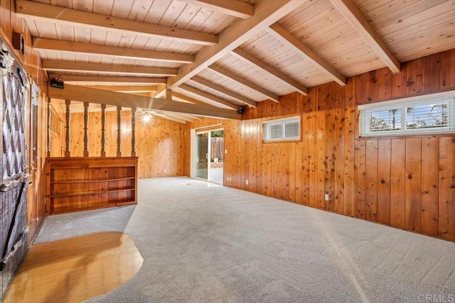 unfurnished living room with a wealth of natural light, carpet, lofted ceiling with beams, and wood ceiling