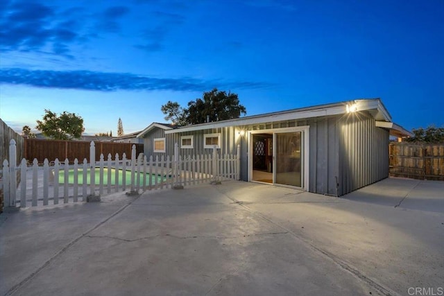 ranch-style house featuring a patio area, a fenced backyard, and board and batten siding