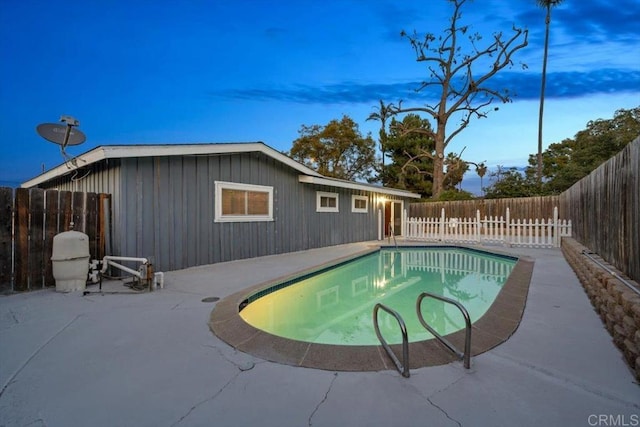 view of swimming pool featuring a fenced backyard and a patio area