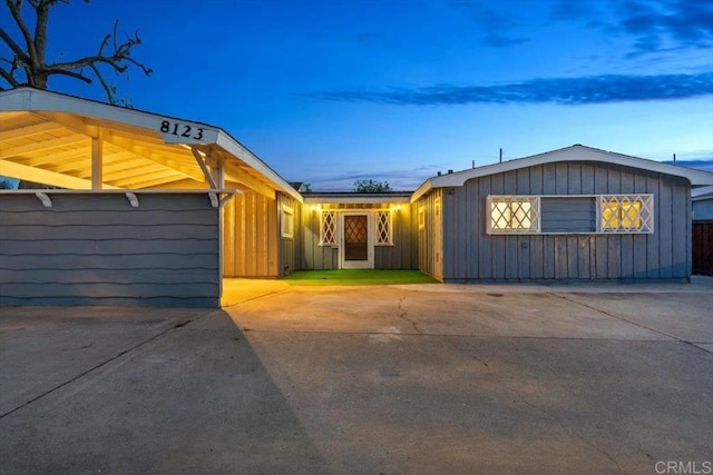 ranch-style home featuring board and batten siding and concrete driveway