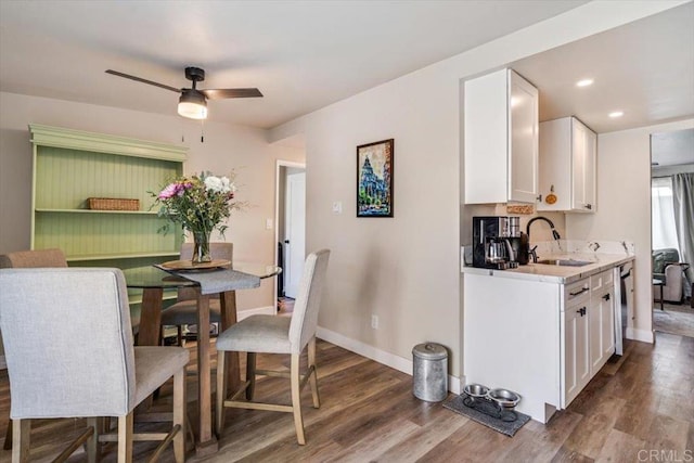 dining space with a ceiling fan, baseboards, wood finished floors, and recessed lighting