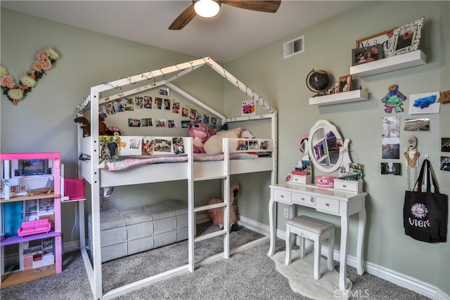 carpeted bedroom with a ceiling fan, visible vents, and baseboards