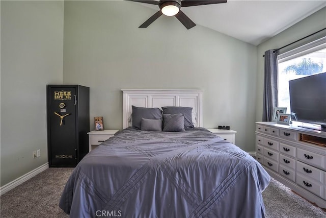 bedroom featuring lofted ceiling, dark carpet, baseboards, and ceiling fan