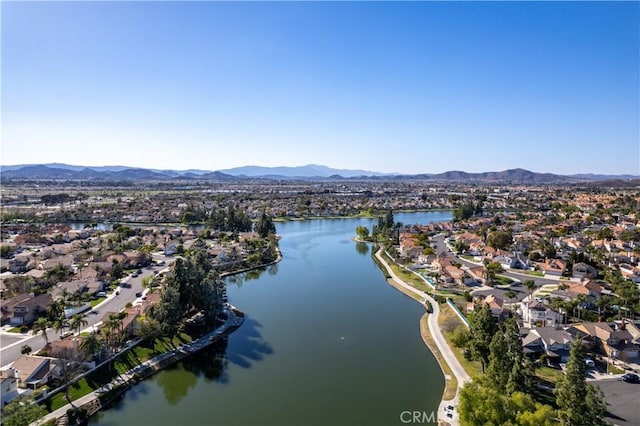 drone / aerial view featuring a water and mountain view and a residential view