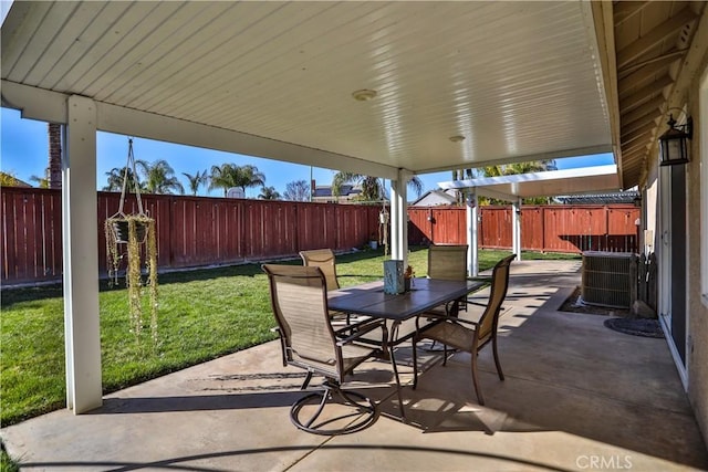 view of patio / terrace with central AC unit, outdoor dining area, and a fenced backyard