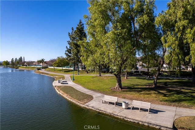 view of home's community featuring a water view and a yard