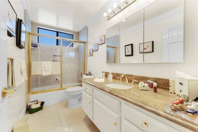 bathroom featuring shower / bath combination with glass door, toilet, ornamental molding, vanity, and tile patterned flooring