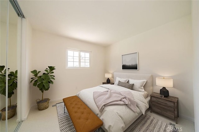 bedroom featuring a closet and light colored carpet