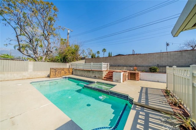 view of swimming pool with a patio area, a fenced backyard, and a pool with connected hot tub