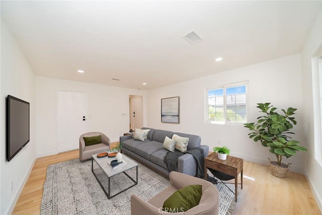 living room with light wood-style floors, recessed lighting, visible vents, and baseboards