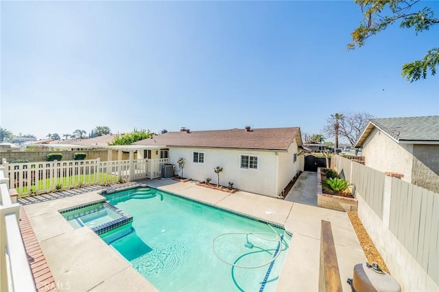 view of swimming pool featuring a pool with connected hot tub, a fenced backyard, a patio, and central AC