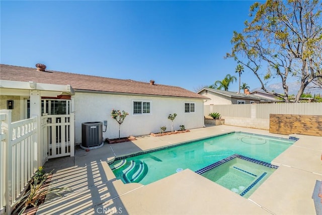 view of swimming pool with french doors, a patio, a pool with connected hot tub, cooling unit, and a fenced backyard