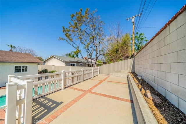 view of patio / terrace featuring a residential view, a fenced backyard, and a fenced in pool