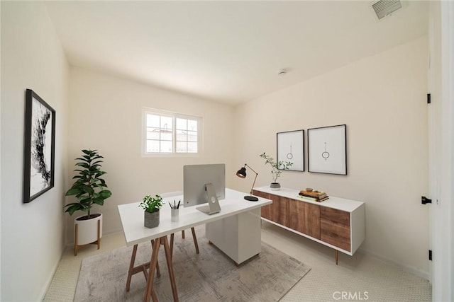 home office featuring baseboards, visible vents, and light colored carpet