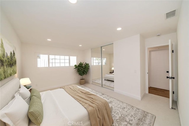 bedroom featuring baseboards, visible vents, light colored carpet, and recessed lighting