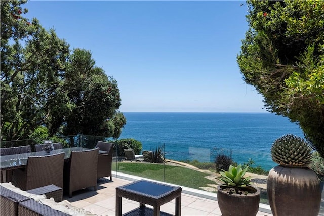 view of patio / terrace featuring a water view and outdoor dining space