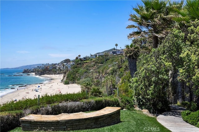 exterior space with a water view and a beach view