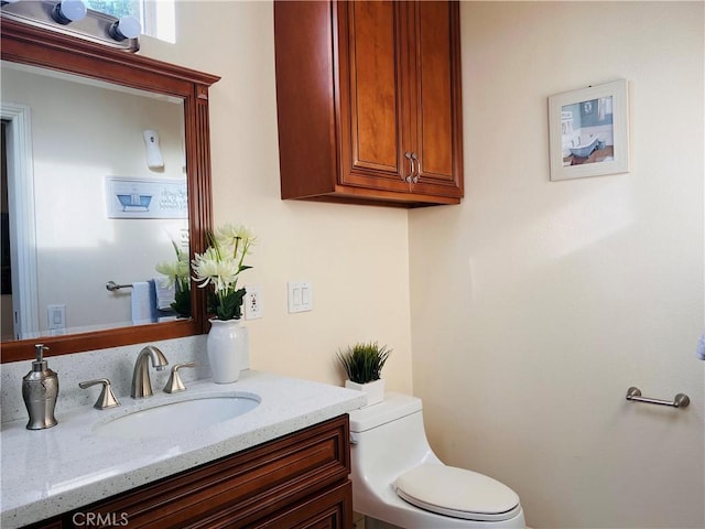 bathroom with toilet and vanity