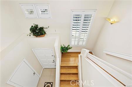 staircase featuring a baseboard heating unit