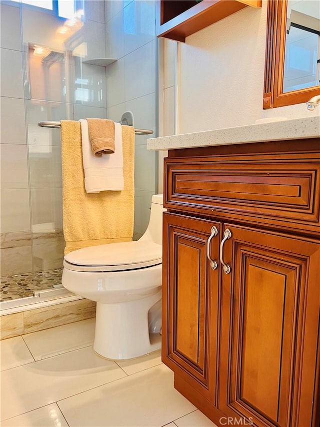 full bath with vanity, tile patterned flooring, a shower stall, and toilet