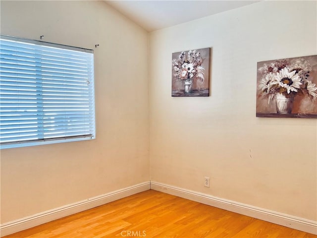 unfurnished room featuring light wood-type flooring and baseboards