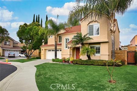 view of front of home featuring a garage, driveway, a front lawn, and stucco siding