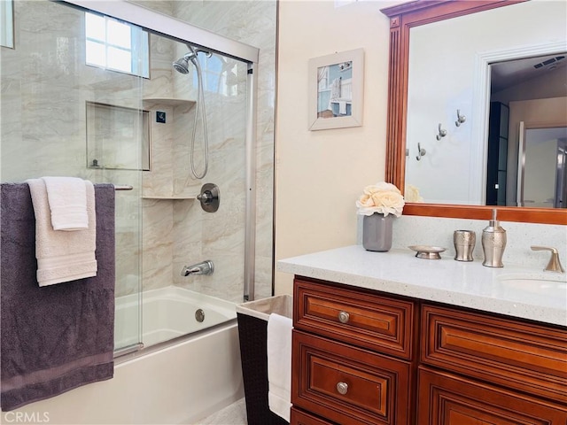 bathroom with enclosed tub / shower combo, visible vents, and vanity