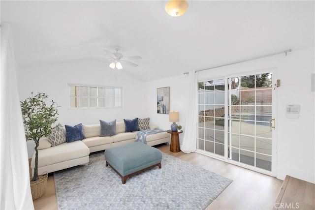 living room with lofted ceiling, ceiling fan, and wood finished floors