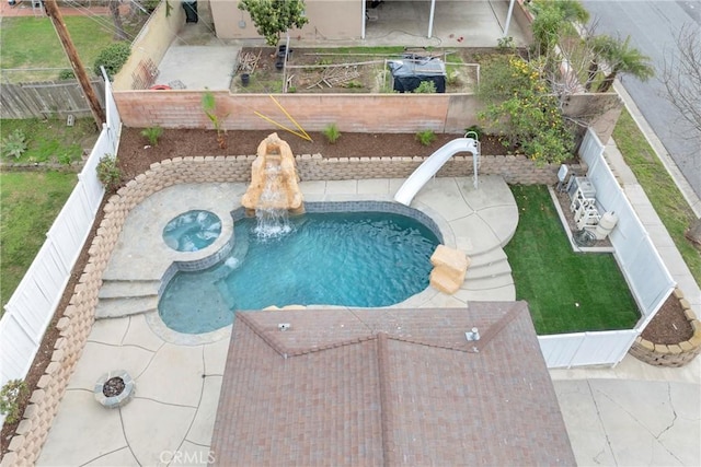 view of pool with a fenced backyard and a water slide