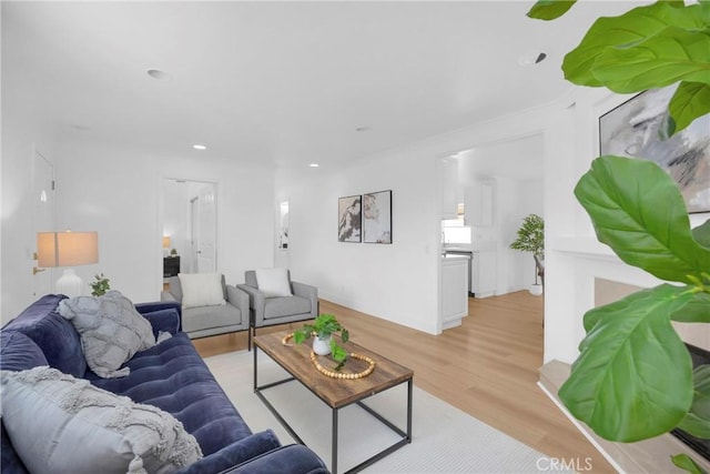 living area with light wood-style flooring and recessed lighting