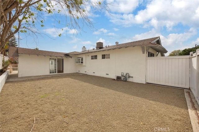 back of house featuring a patio area, fence, and stucco siding