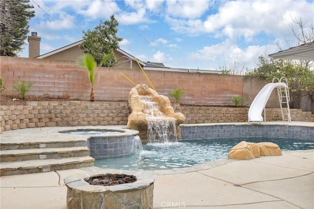 view of pool with a fire pit, a fenced in pool, a fenced backyard, an in ground hot tub, and a water slide