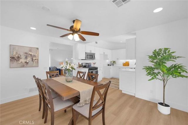 dining space with light wood finished floors, baseboards, visible vents, a ceiling fan, and recessed lighting