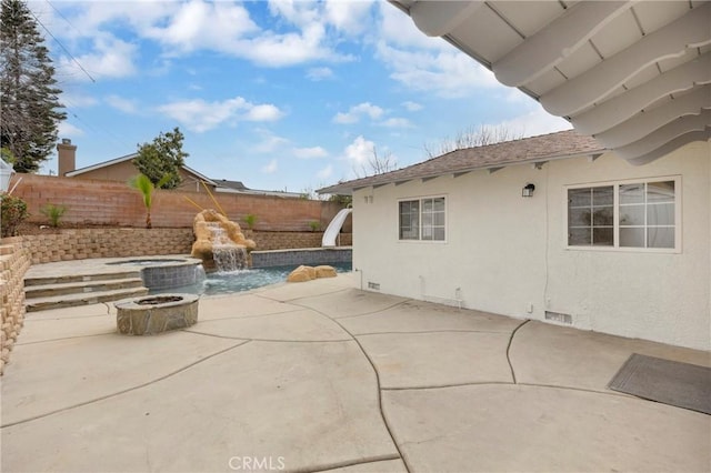 view of patio / terrace with a fire pit, a fenced backyard, visible vents, and a fenced in pool