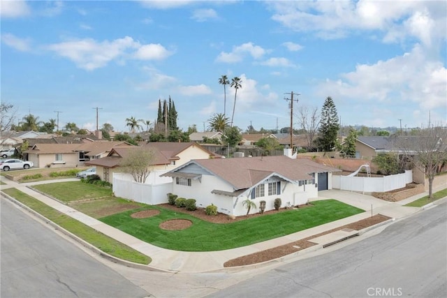 single story home featuring driveway, a residential view, and fence