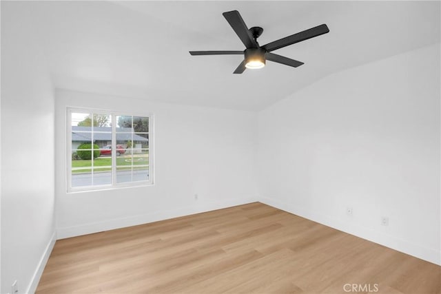 empty room with light wood-type flooring, ceiling fan, baseboards, and lofted ceiling