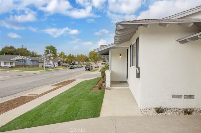 view of home's exterior featuring a residential view and stucco siding