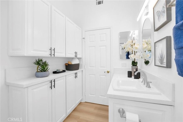 bathroom featuring visible vents, wood finished floors, and vanity