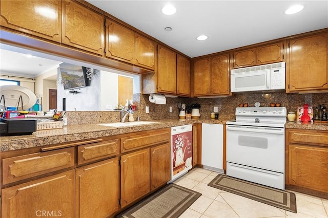 kitchen featuring tasteful backsplash, white appliances, a sink, and tile countertops