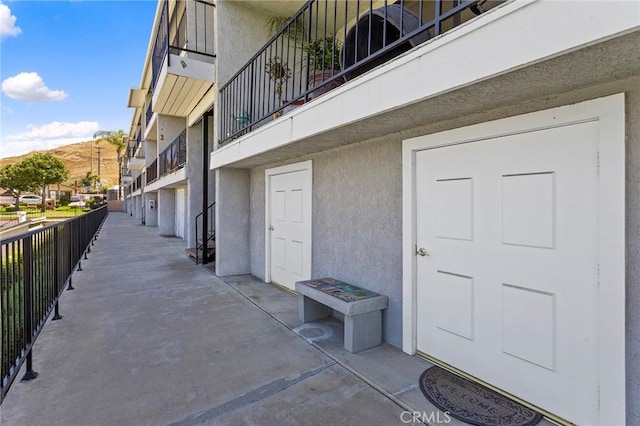22570 Bass Pl Unit 7, Canyon Lake, CA 92587 - view of exterior entry with stucco siding and fence