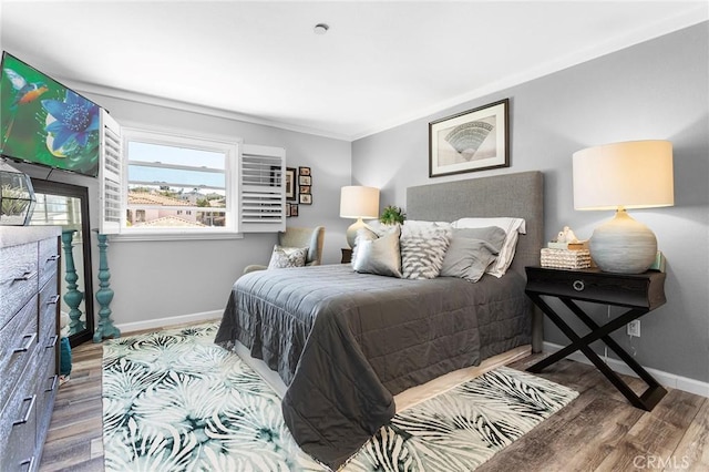 bedroom featuring baseboards and wood finished floors