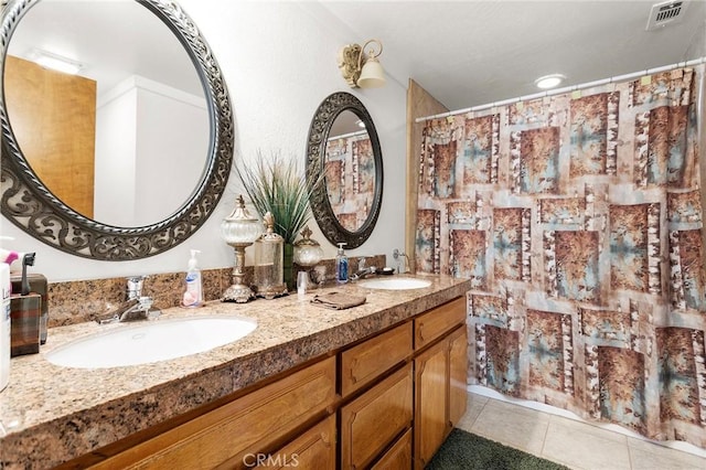 full bath with tile patterned flooring, visible vents, a sink, and double vanity