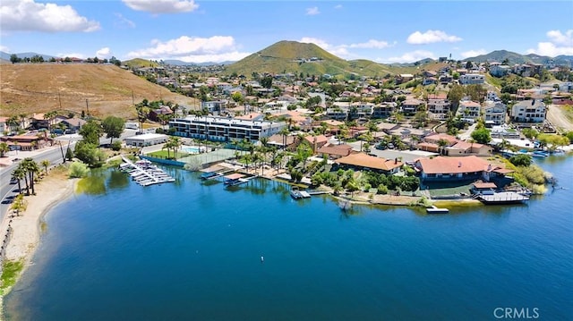 drone / aerial view featuring a residential view and a water and mountain view