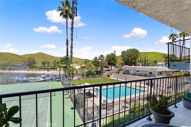 balcony featuring a water and mountain view