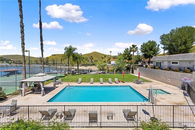 pool with a yard, a water and mountain view, fence, and a patio