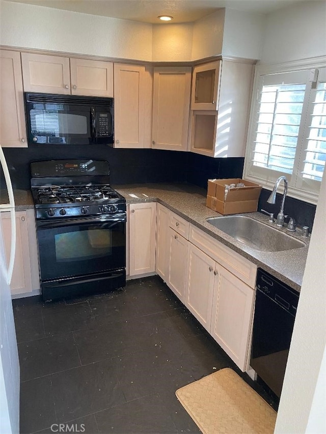 kitchen featuring black appliances, open shelves, and a sink