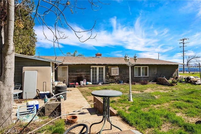 back of property featuring a yard and a patio