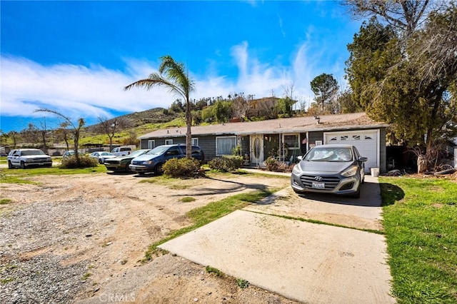 ranch-style home with driveway and an attached garage